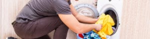 young man doing laundry