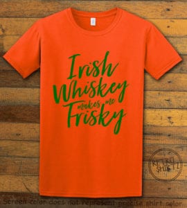Irish Whiskey Makes Me Frisky St Patricks Day Shirts graphic design mocked up on a orange shirt background. Screen color may differ from exact shirt color. Please see product dimensions for exact graphic design size.
